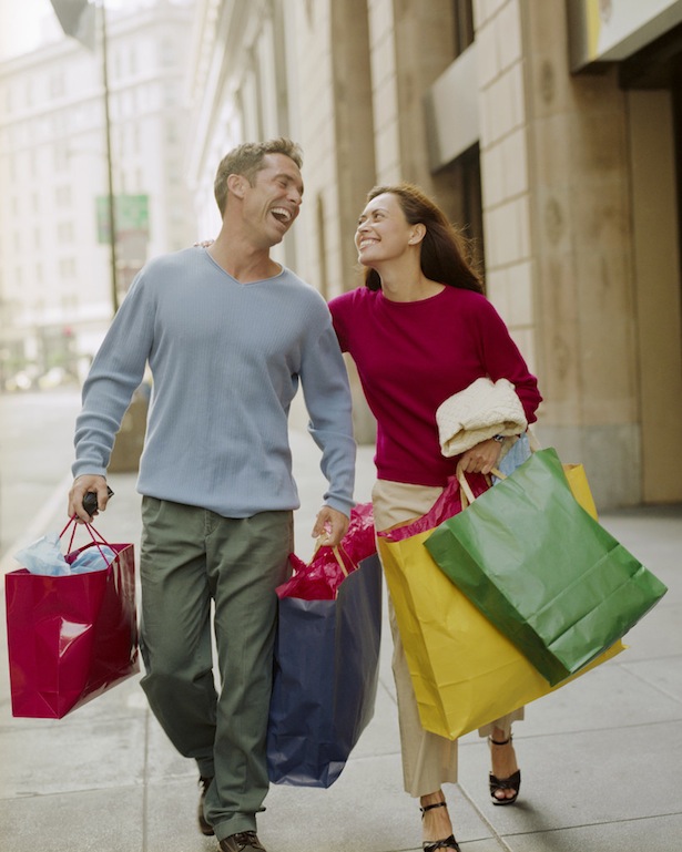 Couple on City Sidewalk with Shopping Bags