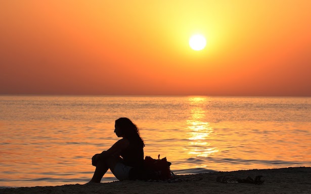 woman_sitting_on_the_beach_at_sunset-other