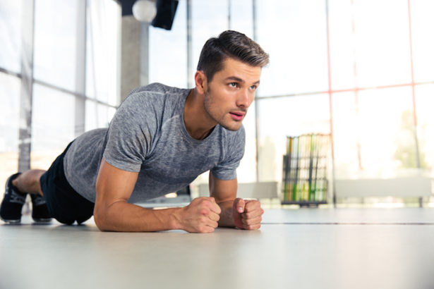 Man doing planking exercise in gym