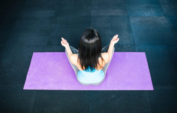 Back view portrait of a woman meditating