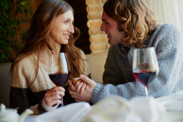 Portrait of amorous young couple spending time in restaurant