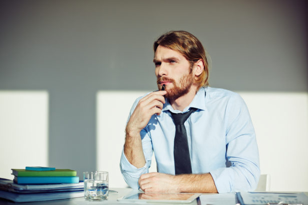 Portrait of pensive designer at his workplace