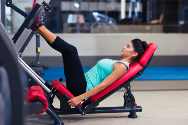 Portrait of a fitness woman workout on exercises machine in gym