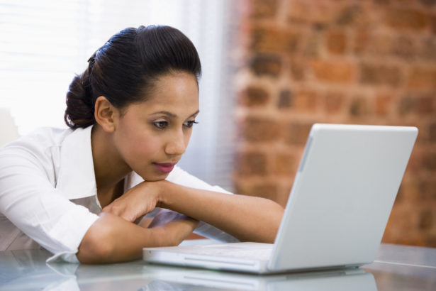 Businesswoman in office with laptop