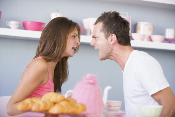 A young couple arguing at the breakfast table